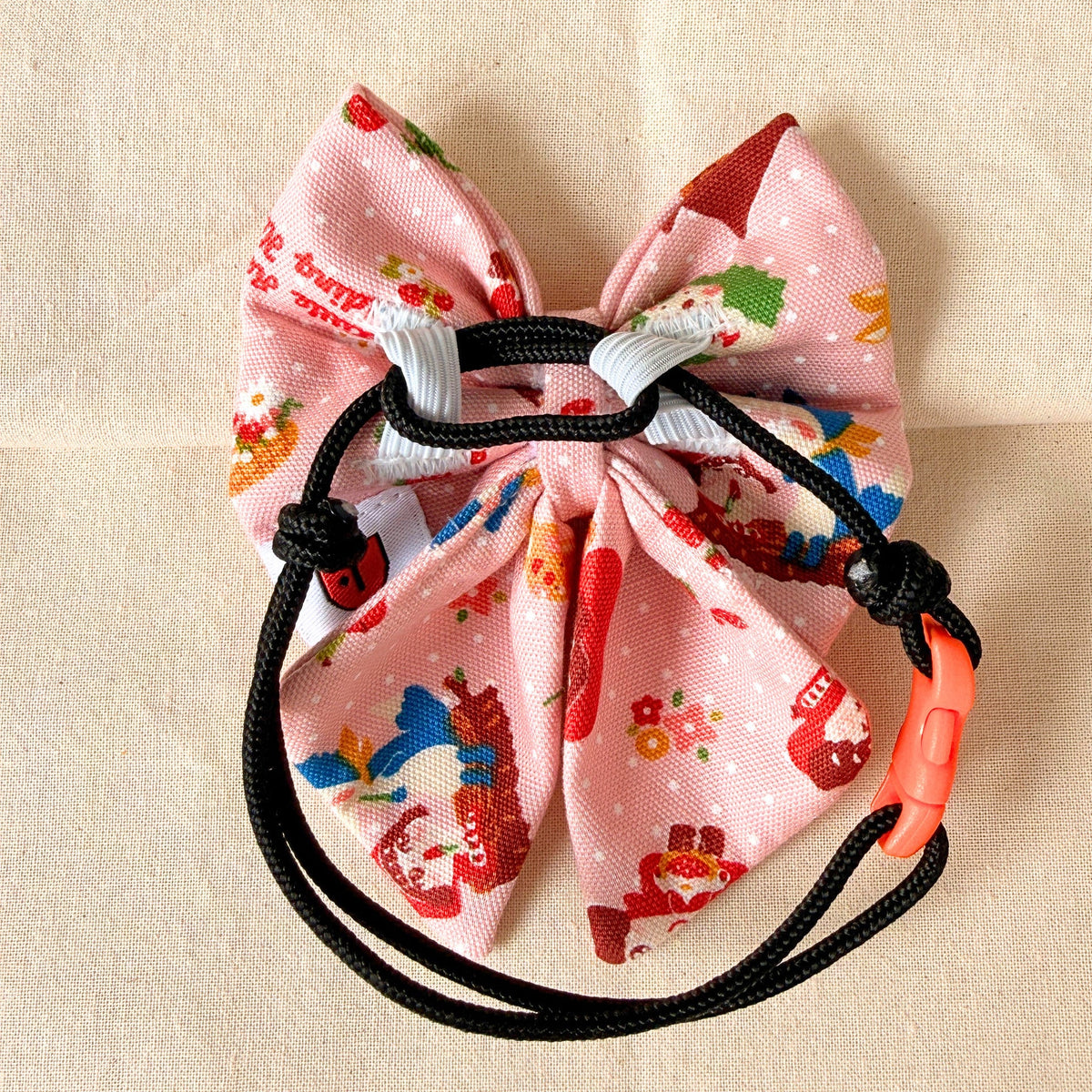 Pink with red riding hood prints on a sailor bow