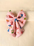 Pink with red riding hood prints on a sailor bow