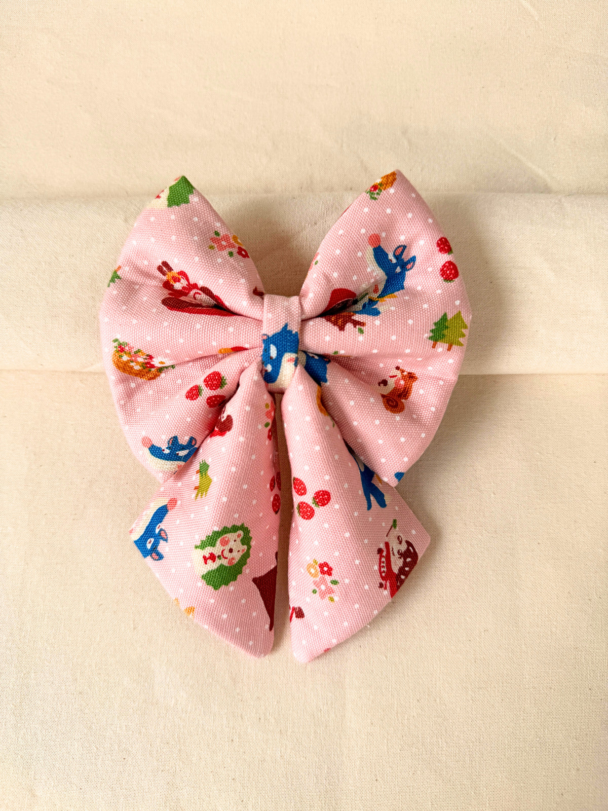 Pink with red riding hood prints on a sailor bow
