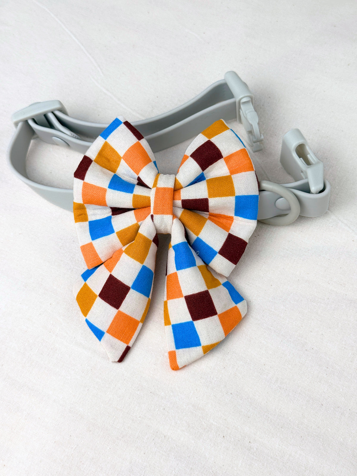multicoloured checkered dog sailor bow on a dog collar